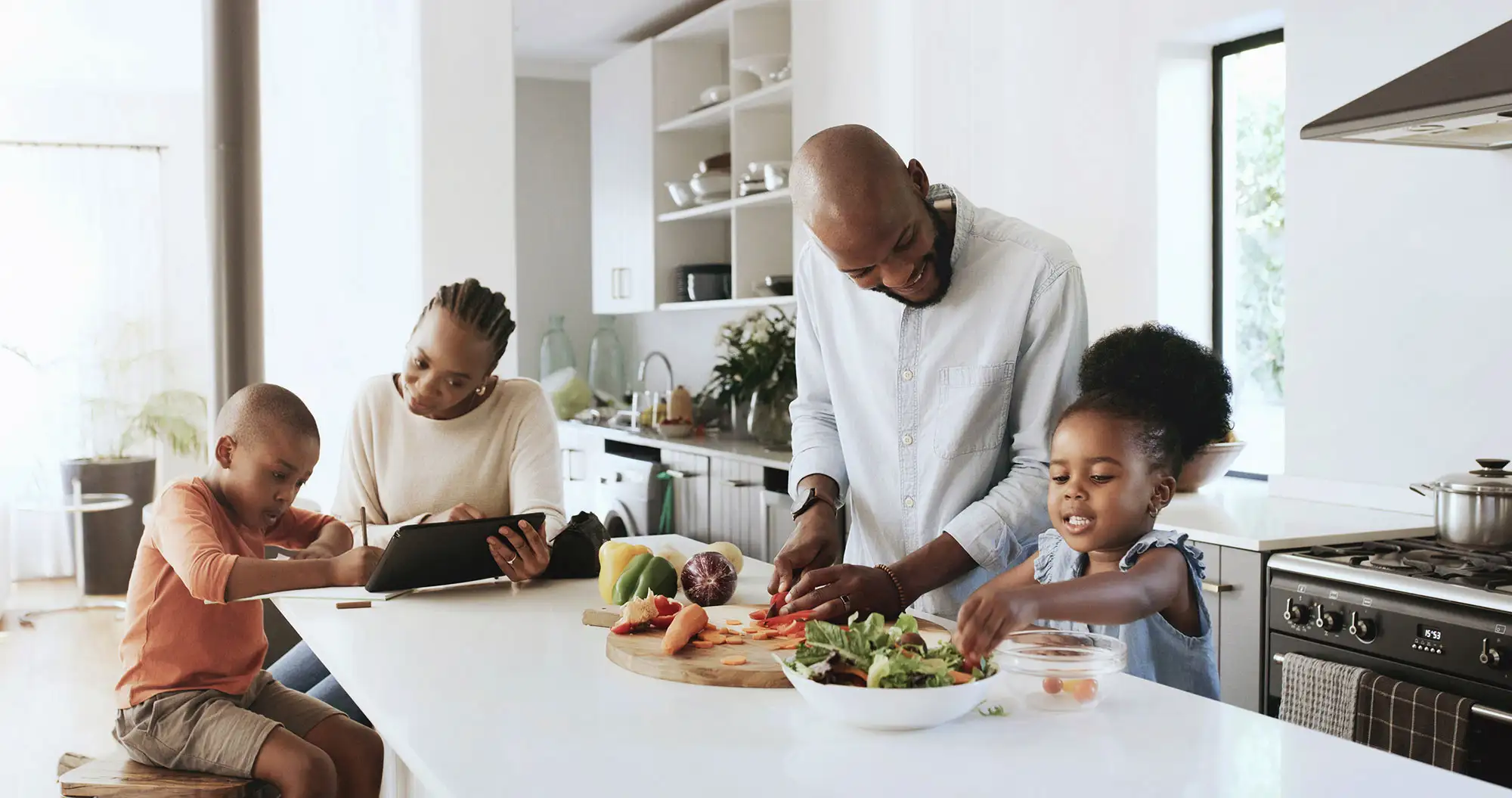 Family cooking together in a bright modern kitchen