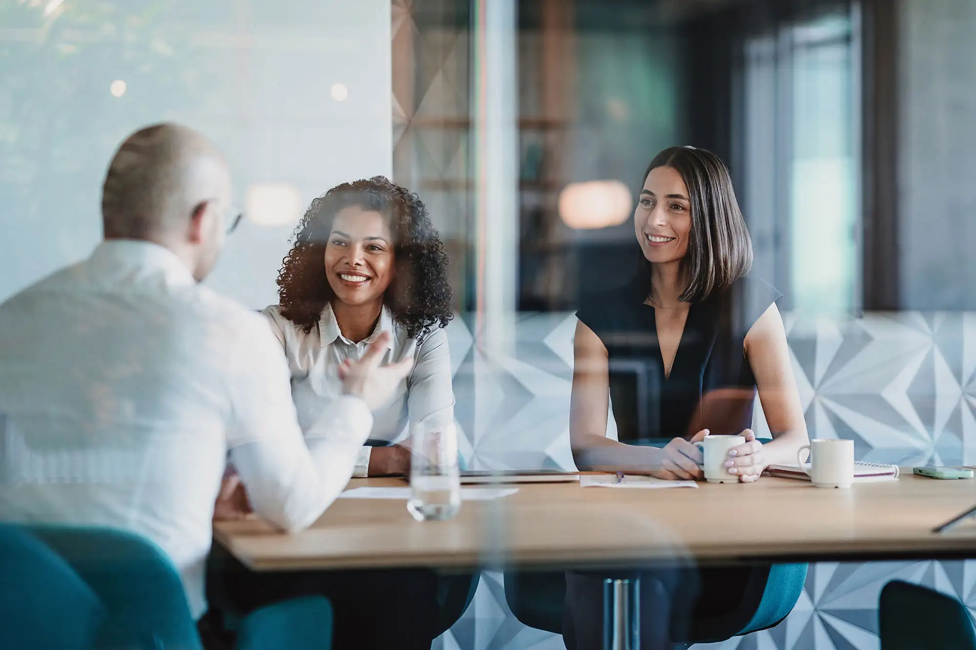 Three professionals having a meeting in a modern office