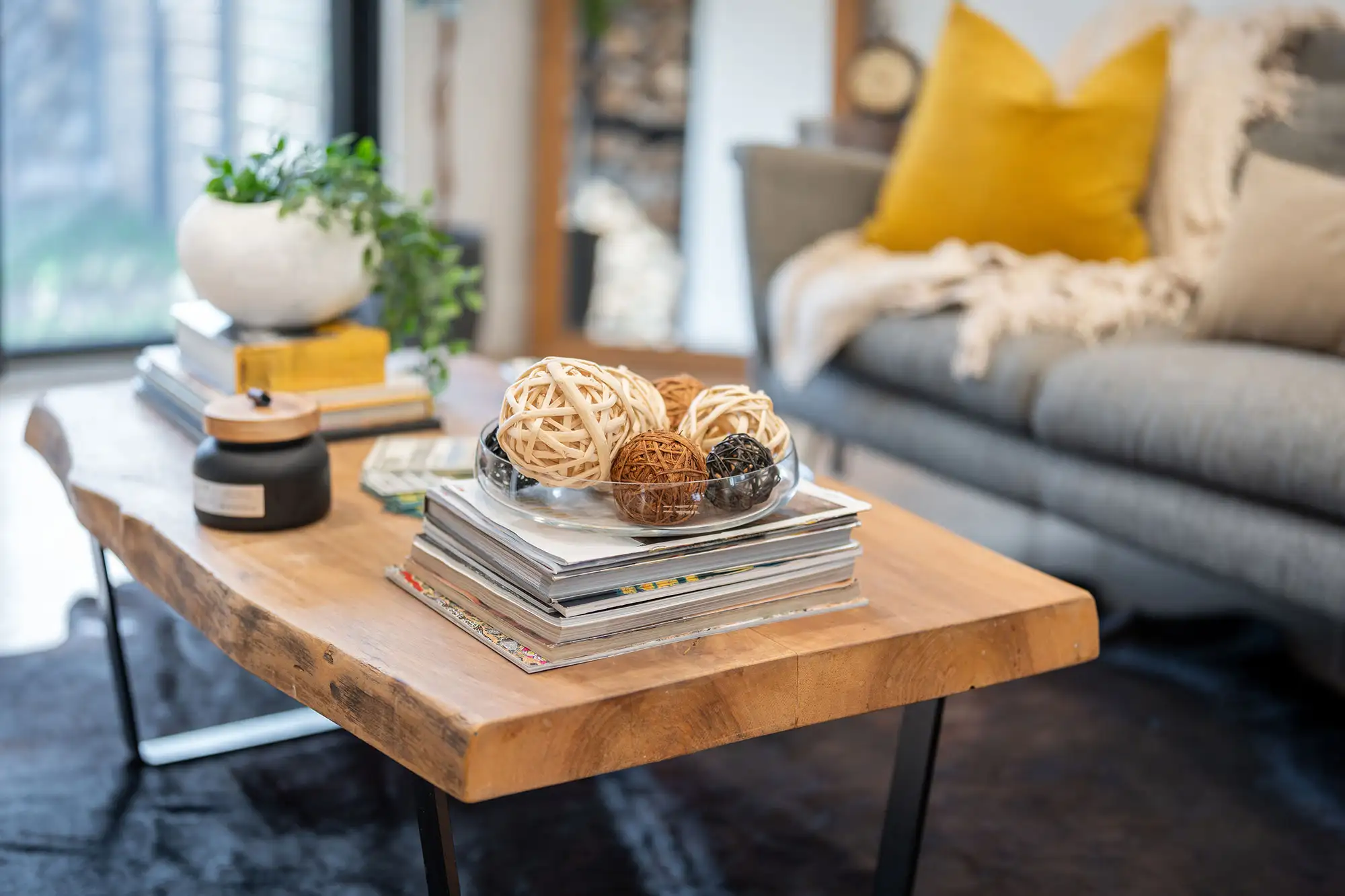Rustic live-edge wood coffee table with decorative wicker balls